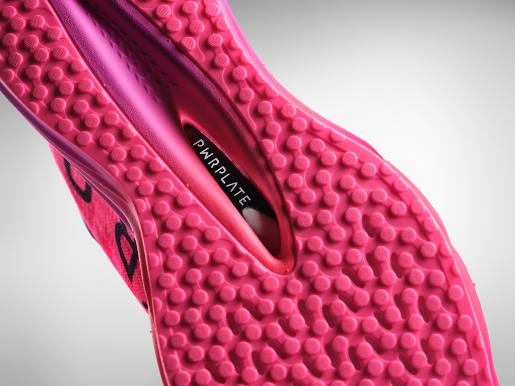 Macro view of the Puma Deviate Nitro Elite 3 outsole, highlighting the PWRPLATE carbon fiber plate for stability and power transfer during HYROX Sled Pushes.