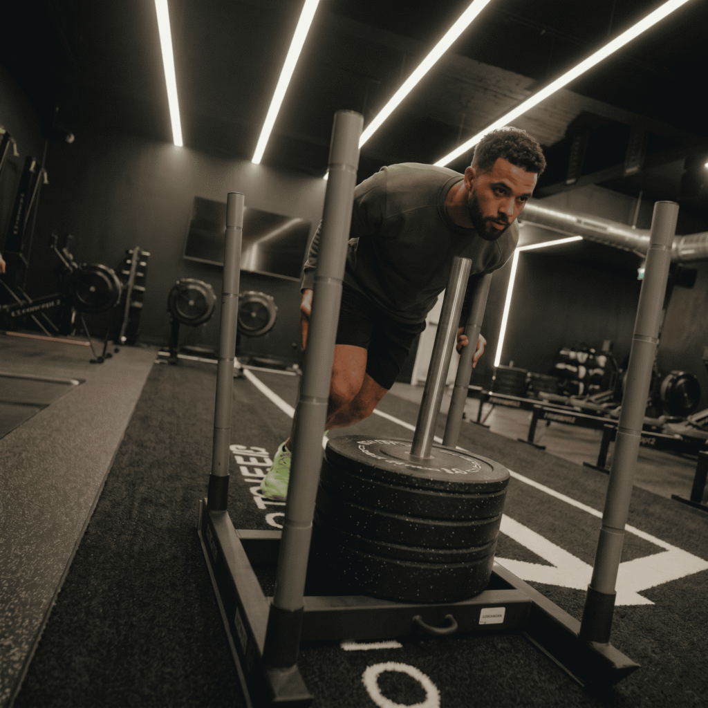 Athlete performing a Sled Push Hyrox with perfect form